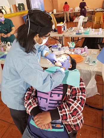 Dr. Kurian working on female patient's smile
