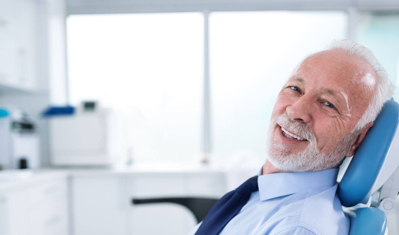 man with beard smiling in exam chair